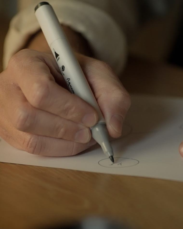 A hand signing at the desk